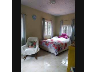 Rustic covered terrace with views to trees and gardens in mountain property Panama