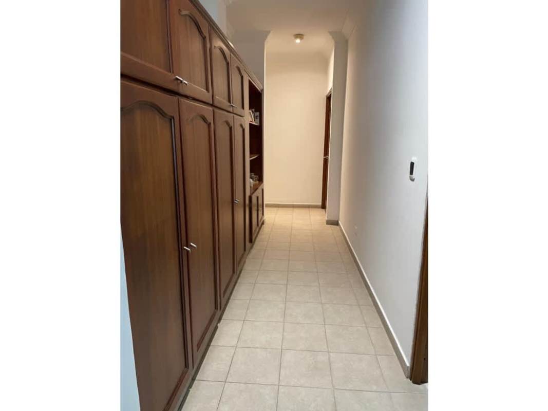Interior hallway with built-in wooden cabinets and tile flooring in PH Quentino San Francisco Panama