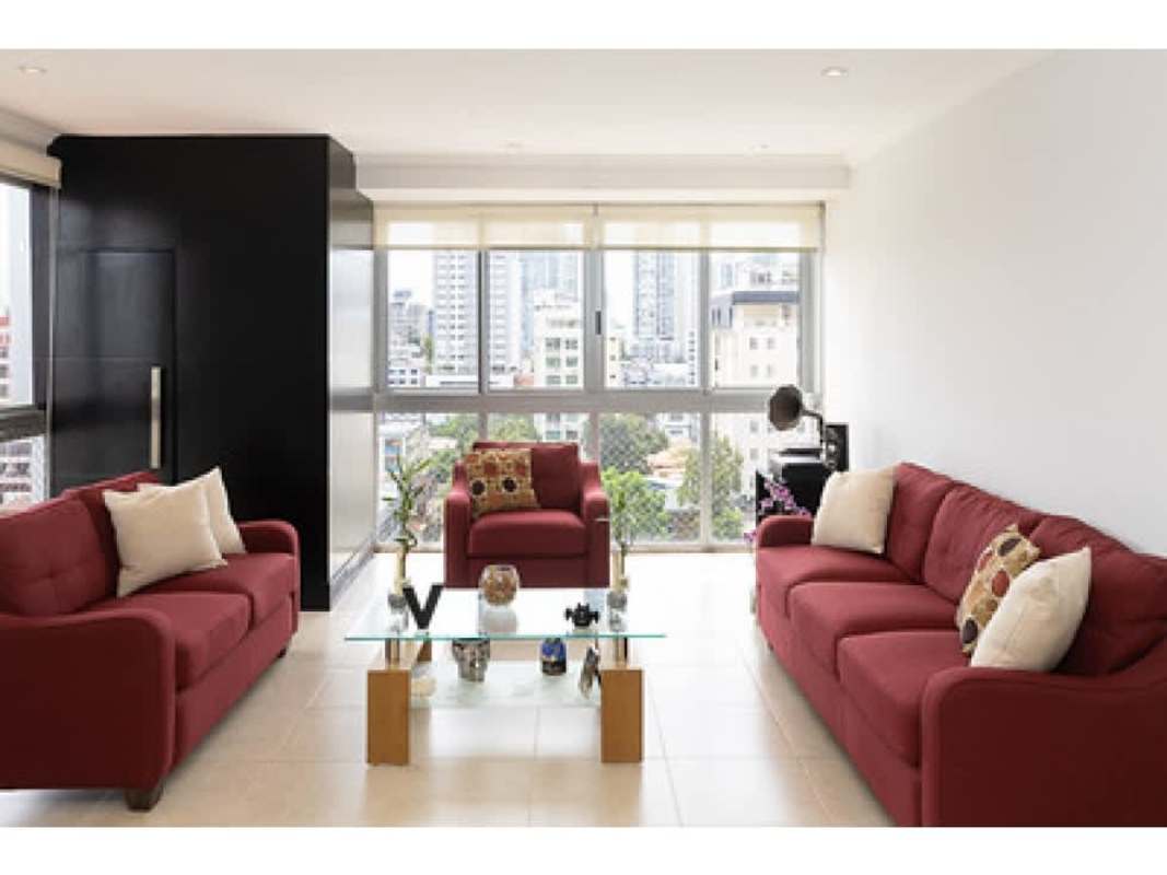 Open concept living with red sofas panoramic windows PH Fairmont Plaza Panama City