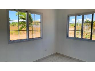 Bedroom with tile floor and garden view in San Carlos beach home Panama