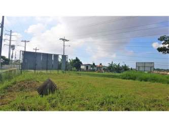 Grassy fenced commercial development land with clear skies Mañanitas Panama