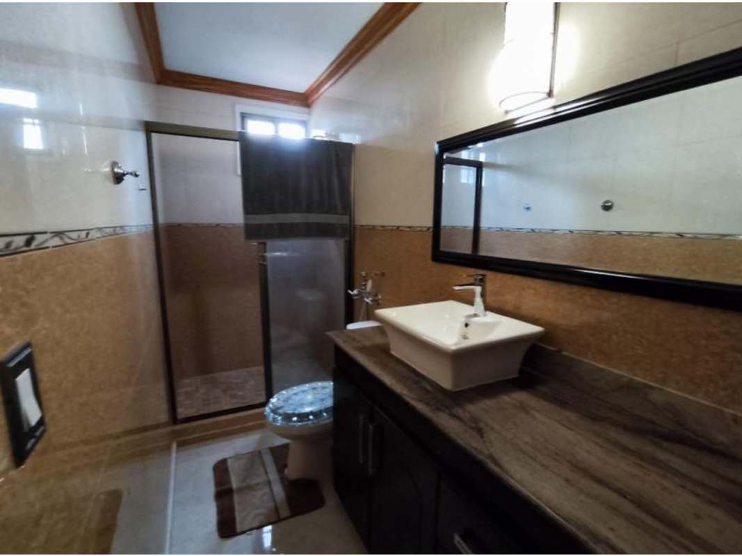 Covered tiled porch with wrought iron gates, fenced yard in Altos de Panamá Condado del Rey Panama