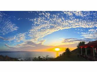 Spacious covered terrace with wooden dining set and panoramic ocean views in Pedasi beach house