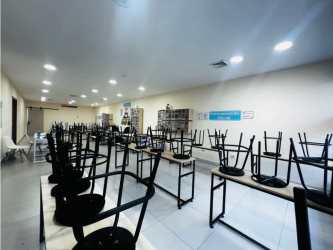 Spacious classroom interior with desks chairs and tile floors Midtown Plaza San Francisco Panama