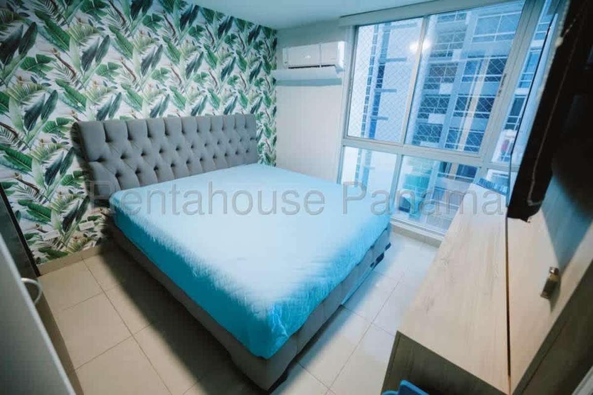Bedroom with tropical wallpaper and floor-to-ceiling window city view Coral Tower Carrasquilla Panama