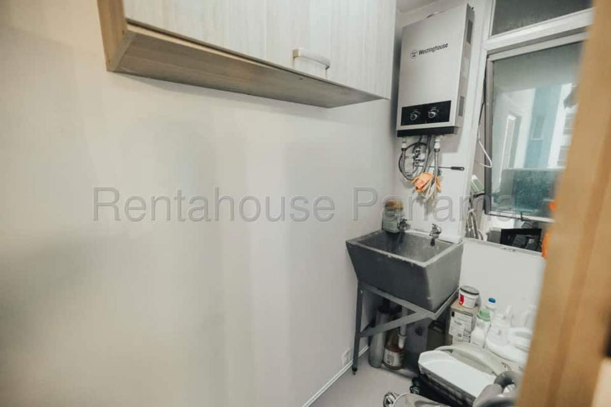 Utility space with water heater, sink, storage Coral Tower apartment Panama City