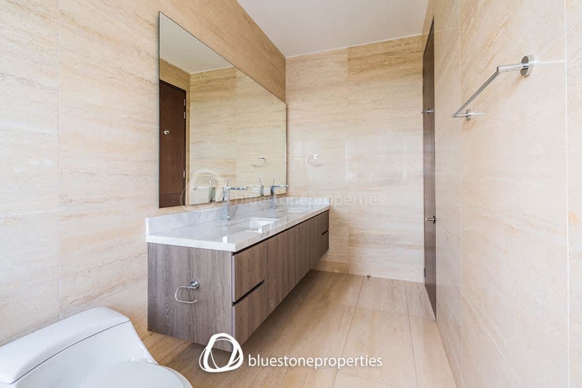 Elegant living-dining area with panoramic sea and golf views in Santa Maria condo