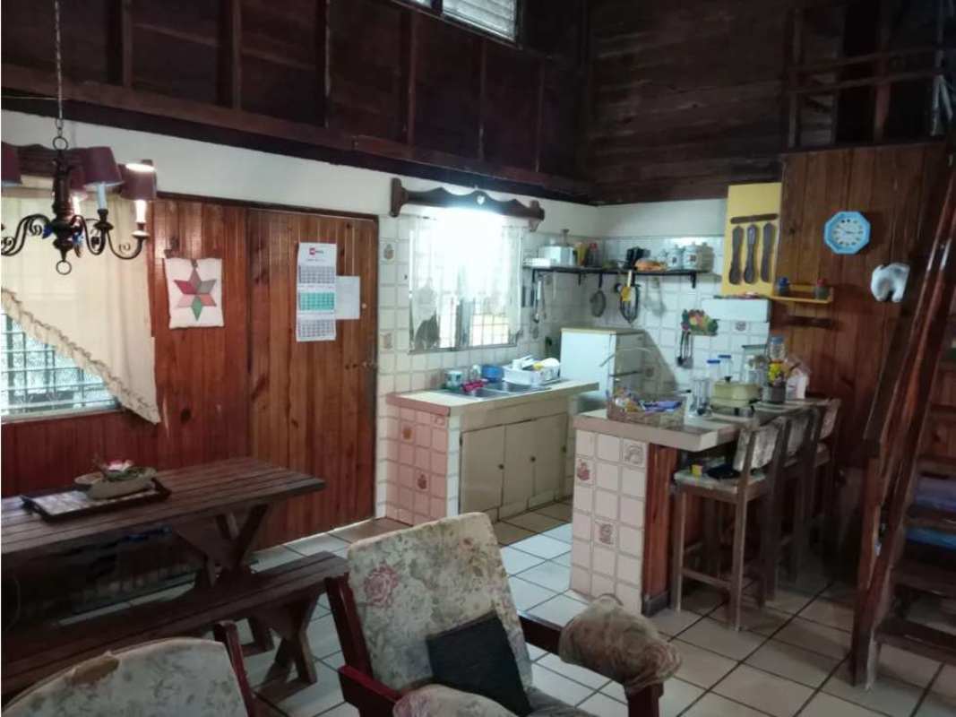 Rustic A-frame cabin surrounded by forest and garden in Cerrro Azul Panama for sale