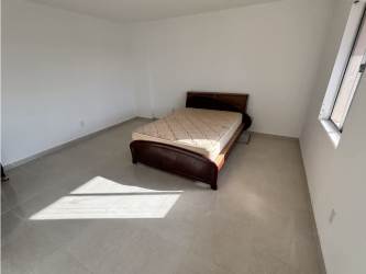 Cozy bedroom with natural lighting and tiled floor in Davis Colón house Panama