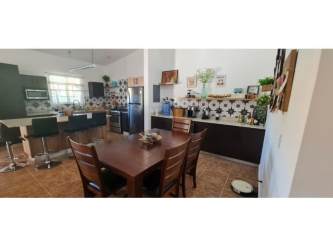 Open concept kitchen dining bar stools eclectic decor Villa Brisas de Lajas