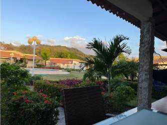 Community swimming pool mountain backdrop patio seating Villa Brisas de Lajas Panama
