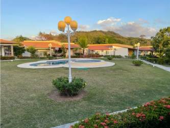 Swimming pool, landscaped garden, club house buildings at Villa Brisas de Lajas near Las Lajas Panama