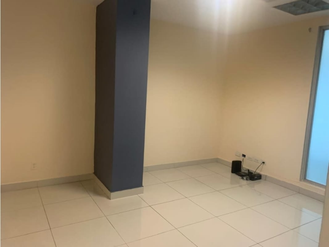Spacious open office area with central column and beige tiled floor in PH Top Tower, Panama City