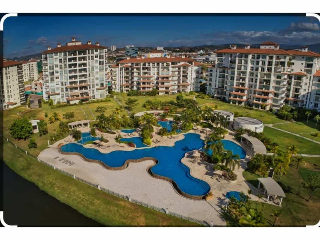 Modern condo tower entrance with landscaped gardens at The Reserve Santa Maria Panama