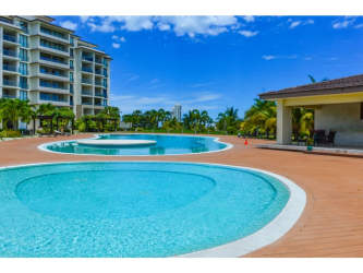 Oceanfront bedroom with glass door to balcony and Pacific views at Casamar PH Perlamar Panama