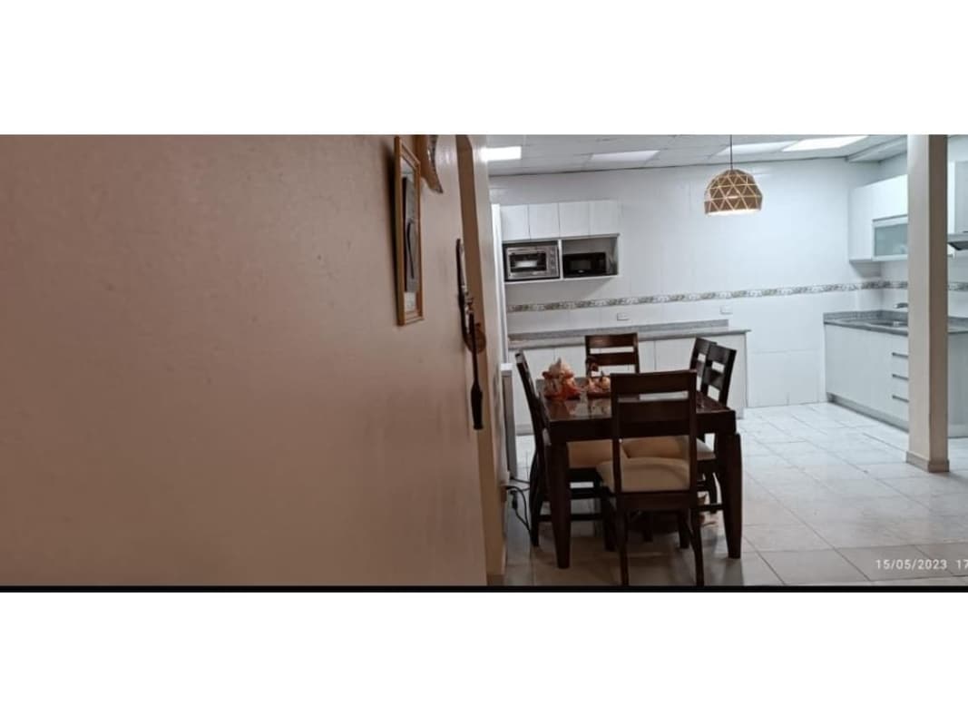 Modern kitchen with granite countertops white cabinets dining space Villa de Vizcaya Condado del Rey