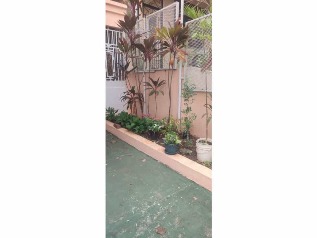 Traditional covered porch rocking chairs tropical garden Villa de Vizcaya Condado del Rey Panama