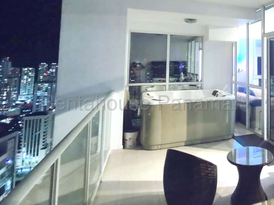 Night view from furnished balcony with jacuzzi overlooking city skyline PH Quadrat Panama