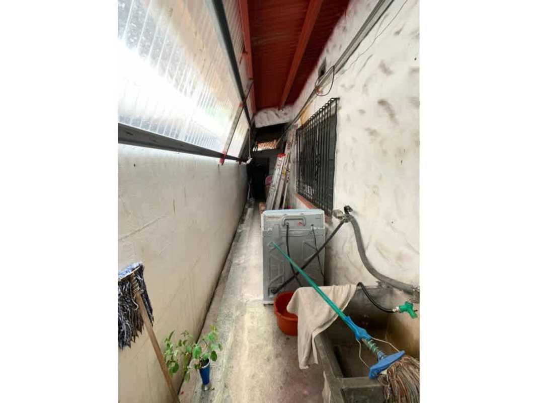 Covered narrow exterior utility space with washing machine Villa de las Fuentes Panama home