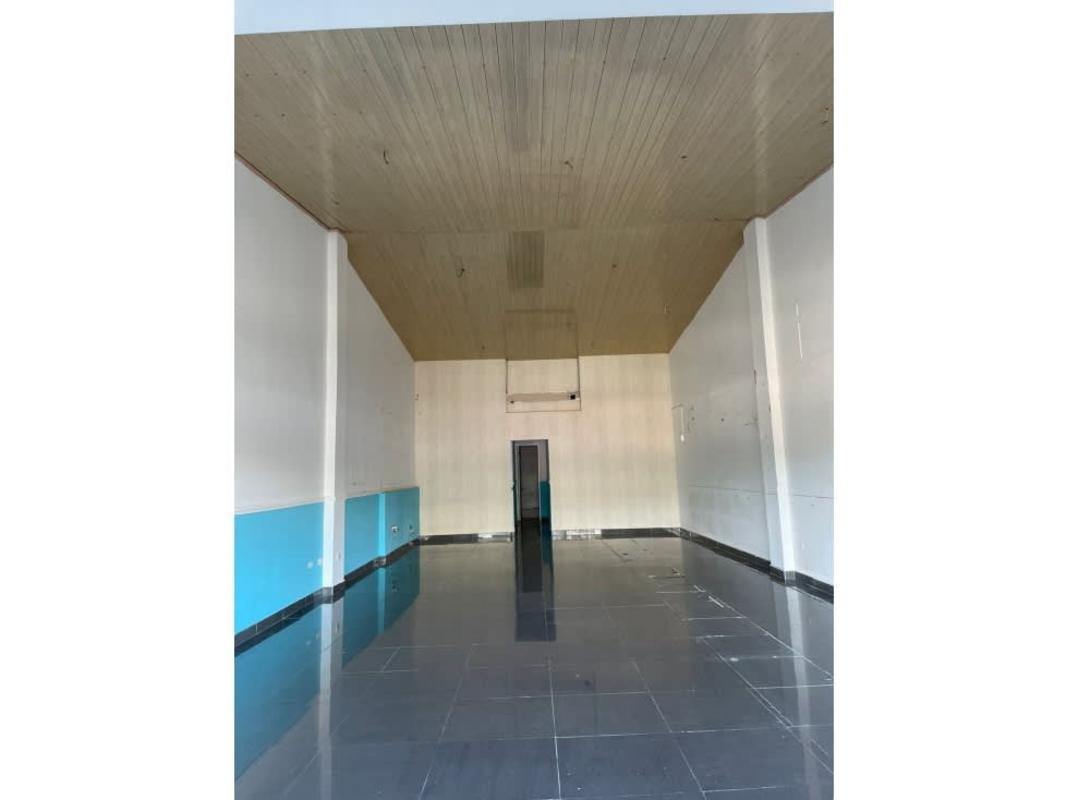 Empty commercial unit interior with high wood-paneled ceiling and tile floors in Plaza Norte Panama City