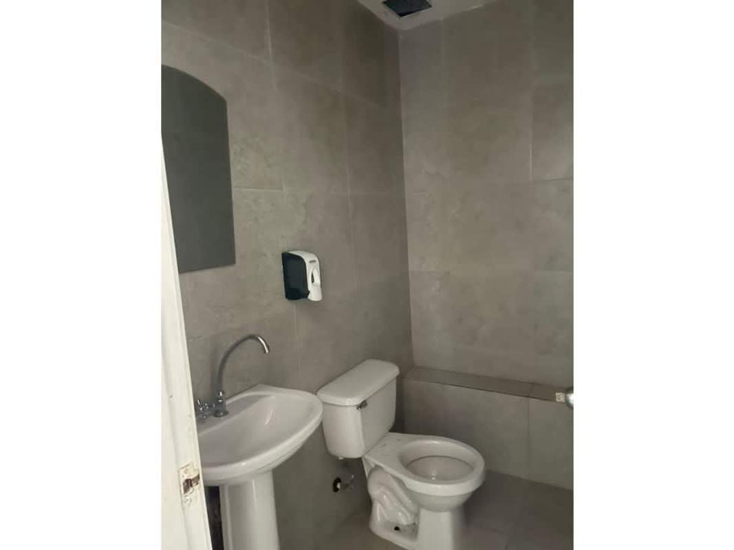 Minimalist bathroom with sink toilet and grey tile walls for commercial use Plaza Norte Altos de Panama