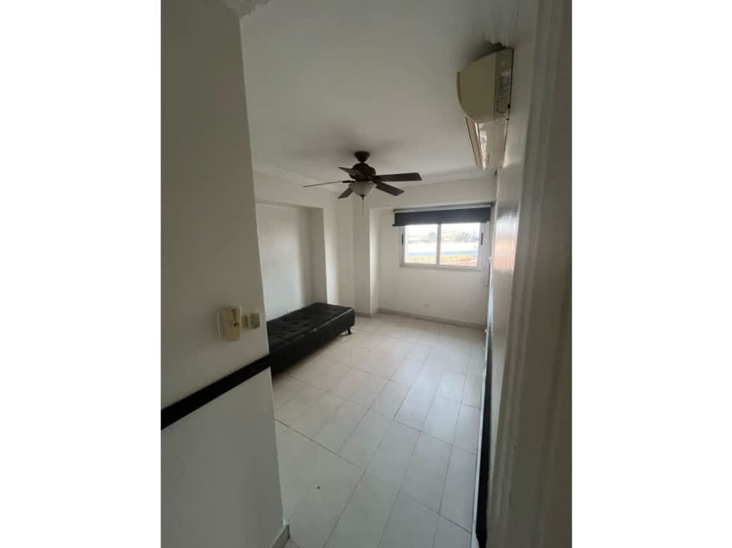 Minimalist bedroom with tile floor, window blinds, ceiling fan, and AC unit PH Park View Panama City