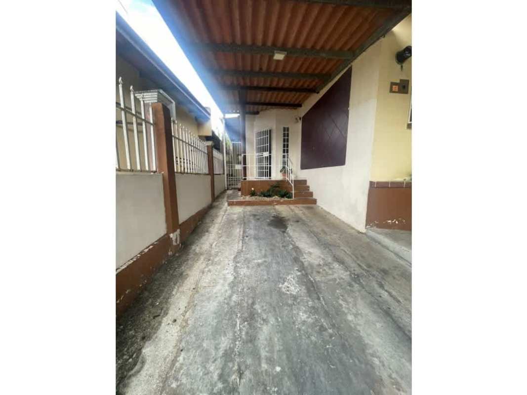 Covered gated driveway and front entry of a house in Altos de la Castellana El Crisol Panama