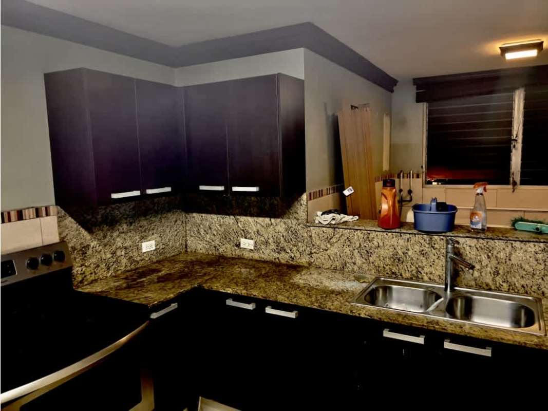 Kitchen area with granite counters, double sink, louvered window PH Cibeles El Dorado Panama