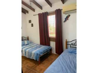 Mediterranean style beach house in Playa Blanca Panama two stories white walls blue roof balcony