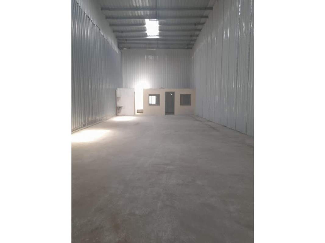 Empty industrial warehouse space with high ceilings and roller doors for rent Tocumen Panama