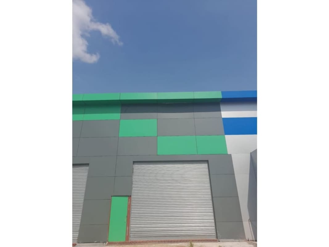 Modern industrial complex colorful facade with large shutter doors warehouse for rent Panama City