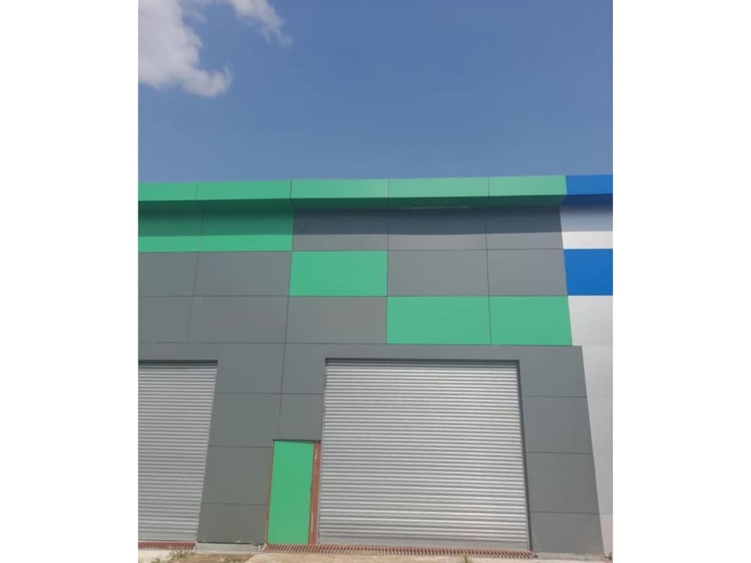 Front of secure industrial warehouse complex colorful modern facade Mañanitas Panama City