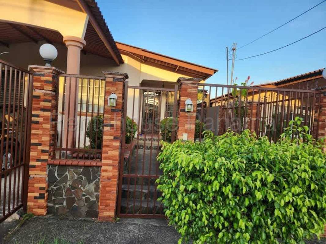 Front gate and landscaped yard of single-family house in Brisas del Golf Panama