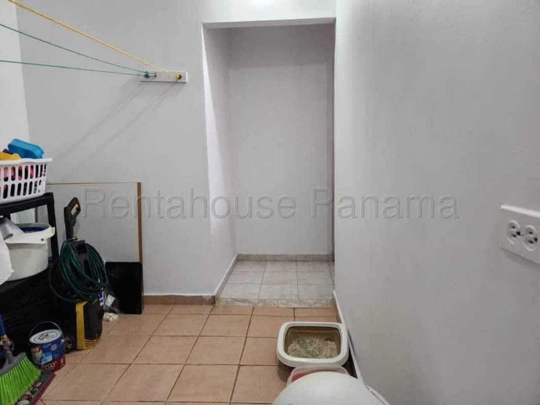 Covered terrace with plants in backyard of Brisas del Golf house Panama