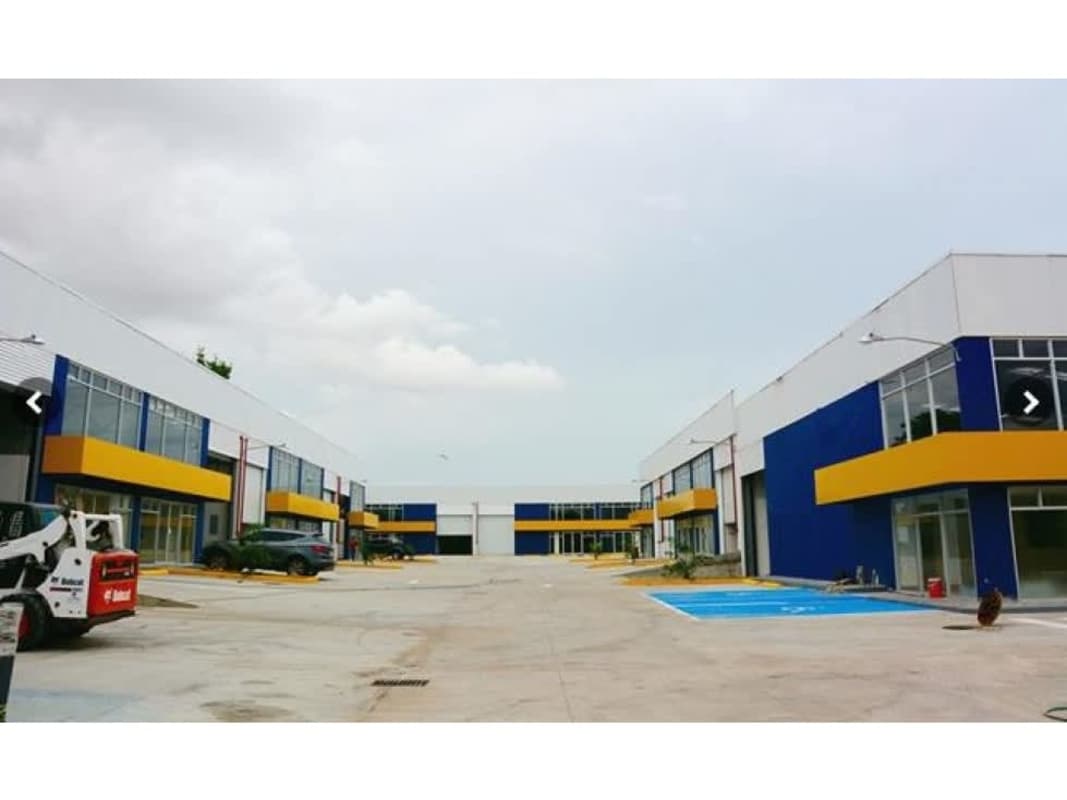 Modern industrial complex with commercial warehouses, parking lot and business signage in Panama City