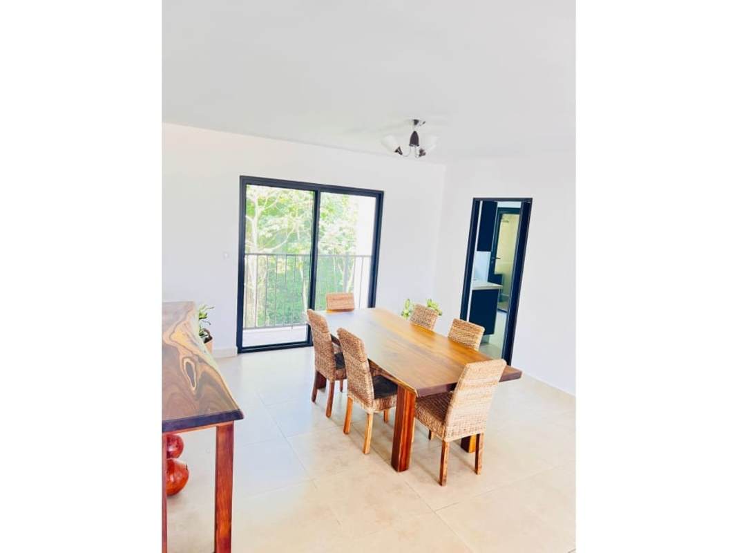 Bright dining room with sliding doors to balcony greenery Embassy Village Albrook Panama