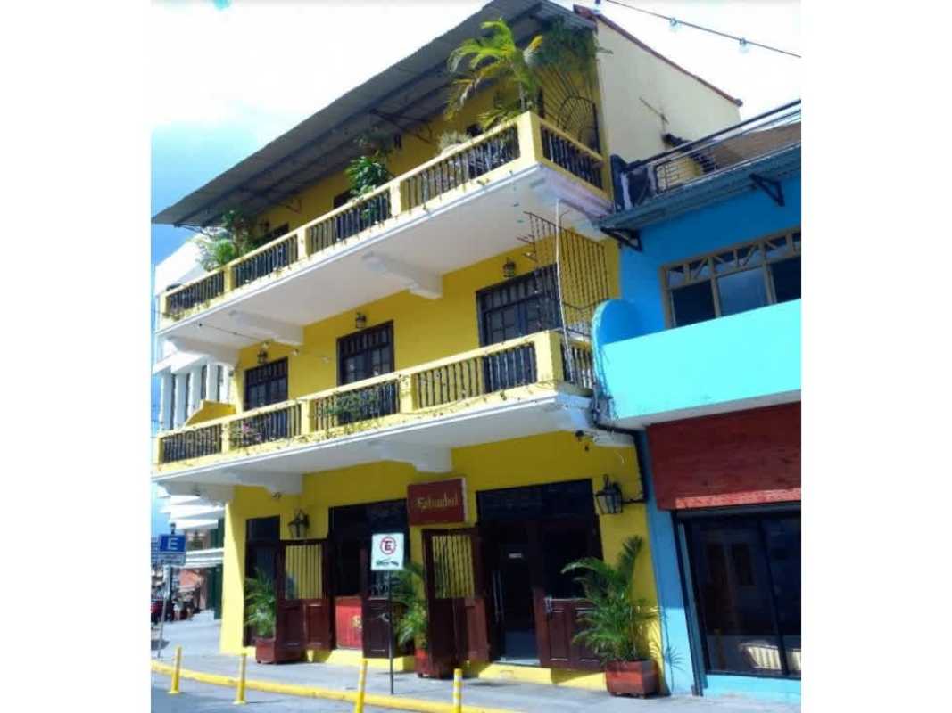 Colorful yellow colonial commercial building with balconies at Casa Catalina in Casco Viejo Panama