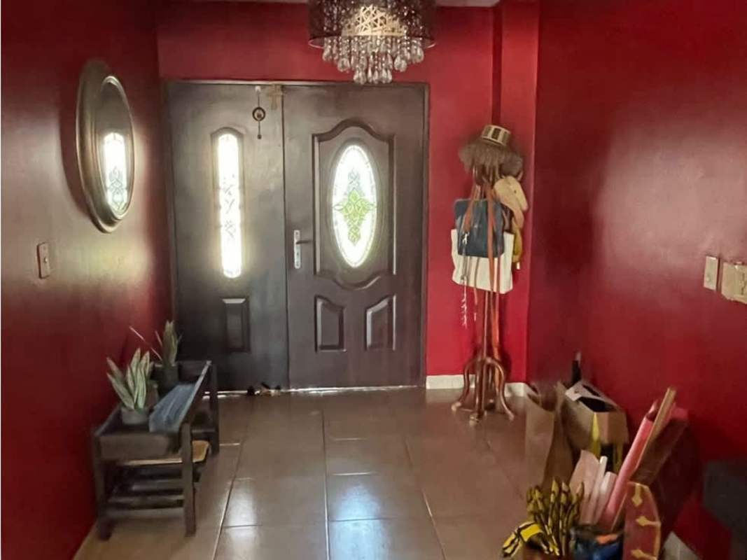 Open plan living room and dining room with tile floors and ceiling fans in Altos de Panamá house