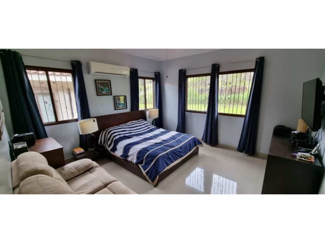 Modern open kitchen with granite counters, cabinetry inside PH Green Village Las Cumbres townhouse Panama