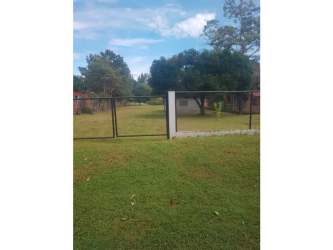 Grassy lot with perimeter fence close to beach and highway in Panama