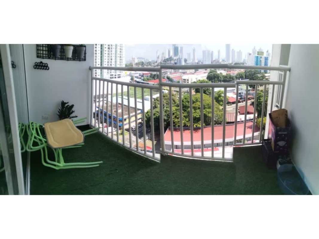Modern apartment balcony with artificial grass, wall planters, skyline view at PH Valy Tower Panama