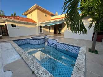 Private swimming pool with tiled deck surrounded by garden in countryside estate Panama
