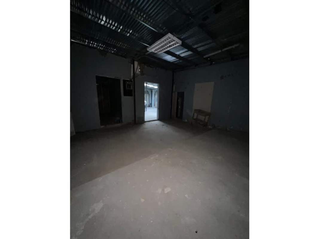 Dark unfinished commercial interior with concrete flooring in Casa de los Arcos Casco Viejo Panama