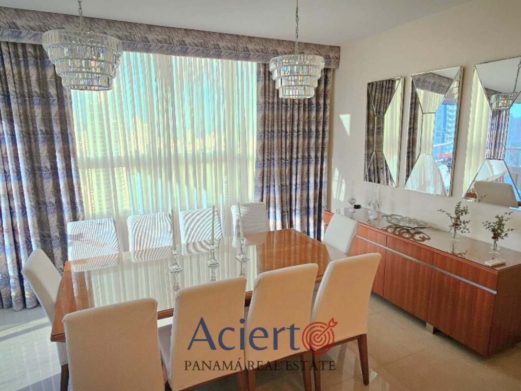 Dining room with chandelier and large window city view in PH Coral Tower Panama apartment