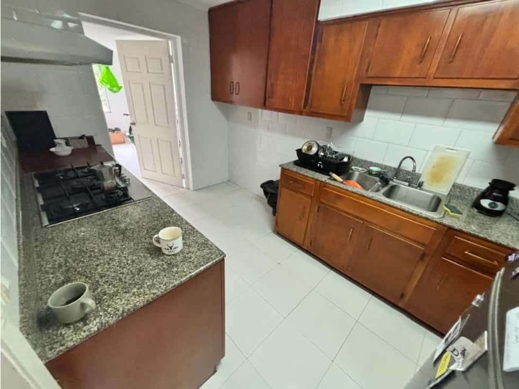 Balcony terrace with tiled floor metal railing lush greenery at Embassy Village Panama