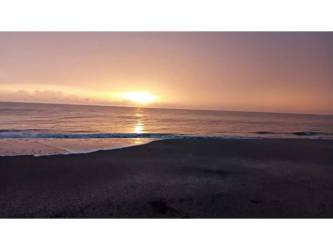 Sunset view over calm Pacific ocean from sandy beachfront Pocri Los Santos Panama