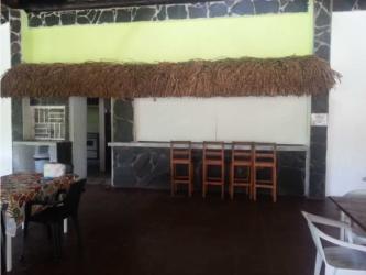 Indoor tropical bar with thatched palapa style roof in restaurant by beach Panama
