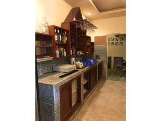 Rustic tropical hut with thatched roof featuring hammocks and garden in Río Hato