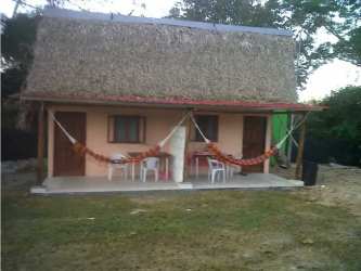 Traditional beach house with red gabled roof and garden in Farallón Riverfront Panama