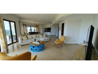Elegant living room with large windows, balcony access, stylish furnishings in PH Las Olas Panama